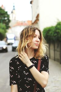 Beautiful young woman standing on road