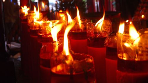 Illuminated tea light candles on table