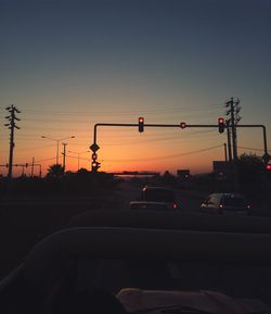 Cars on road at sunset