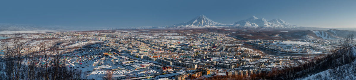 Aerial view of cityscape against sky during winter