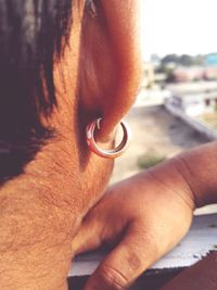 Cropped image of man wearing earring