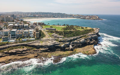 High angle view of sea and buildings against sky