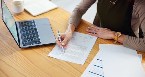 Midsection of business people working on table
