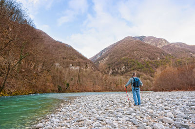 Full length of man standing on mountain against sky