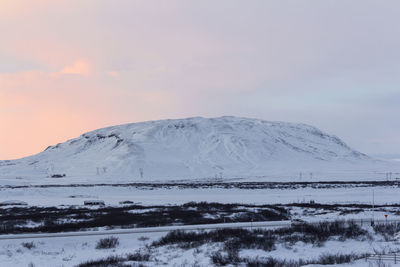 Scenic view of snowcapped mountains against sky during sunset