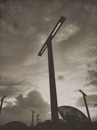 Low angle view of silhouette windmill against sky at sunset