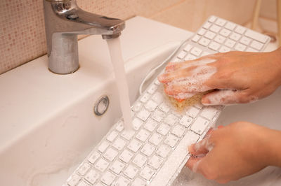 Cropped hand washing hands