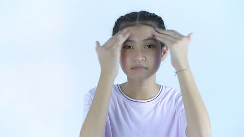 Portrait of a teenage girl against sky