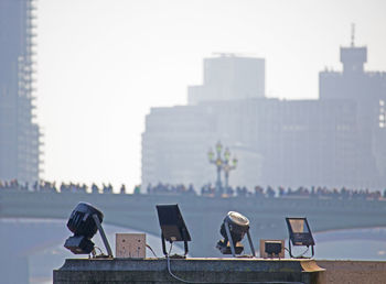 People sitting against buildings in city