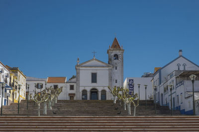 Low angle view of building against clear blue sky