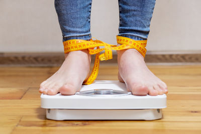 Low section of woman standing on table