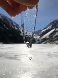 Cropped hand holding ice