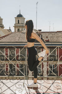 Sportwoman stretching on a rooftop. healthcare lifestyle concept.