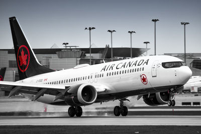 Airplane on airport runway against the sky