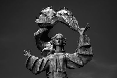 Low angle view of statue against sky