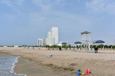 People on beach against sky