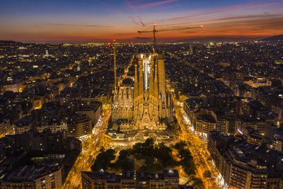 High angle view of illuminated cityscape against sky during sunset