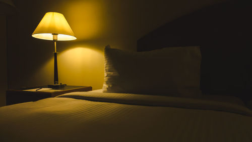 Electric lamp on bed at home