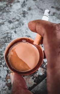 High angle view of hand holding drink