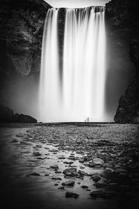 Scenic view of waterfall against sky