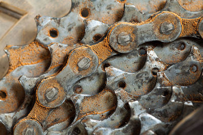 Close-up of rusty bicycle chain in industry