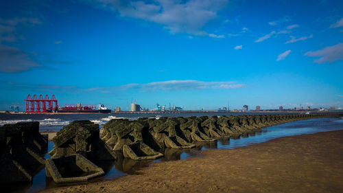 Panoramic view of beach against blue sky