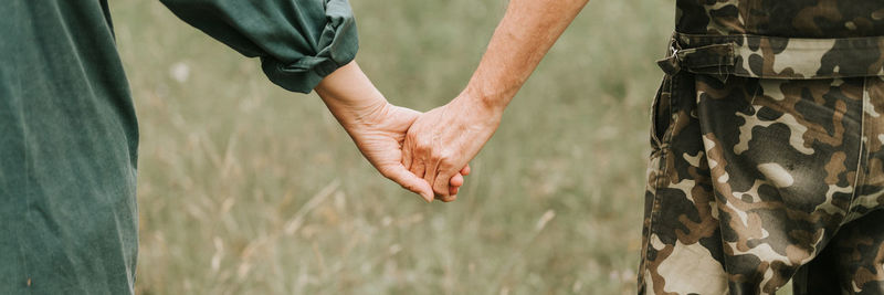 Happy senior couple holding hands. hands of man and woman hold each other. romance and love