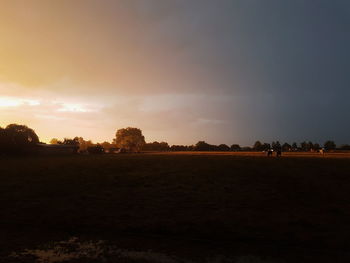 Scenic view of field against sky during sunset