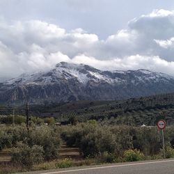 Country road against cloudy sky