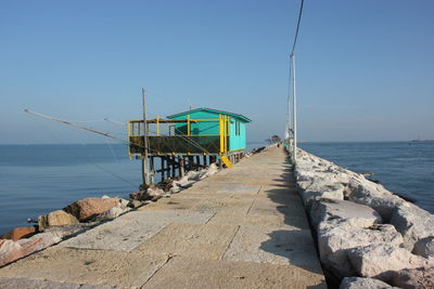 Lifeguard hut on beach against clear sky