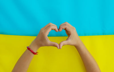 Cropped hand of woman holding yellow