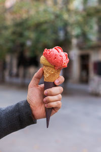 Cropped hand holding ice cream cone