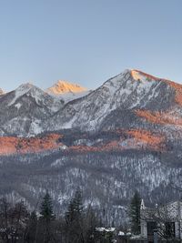 Scenic view of snowcapped mountains against clear sky