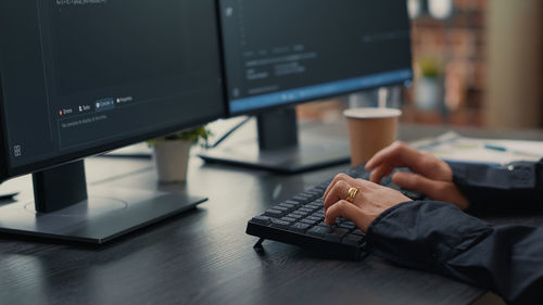 Midsection of man using laptop