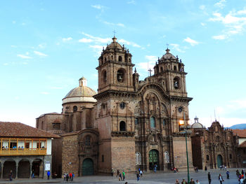 People at cathedral against sky