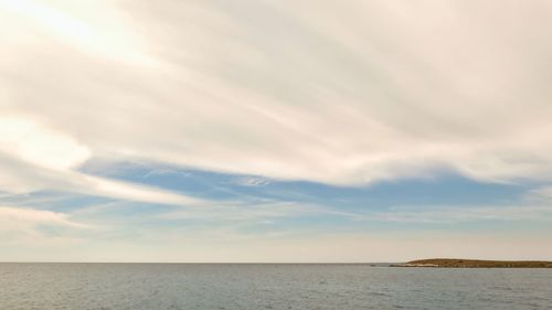 Scenic view of calm sea against blue sky