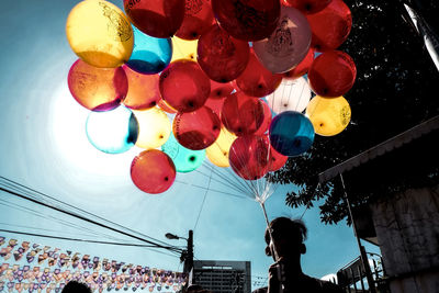 Low angle view of balloons hanging against clear sky