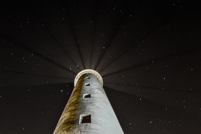 Low angle view of tower against sky at night