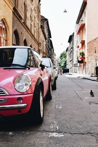 Car on street amidst buildings in city