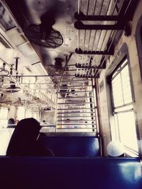 Rear view of woman sitting in corridor