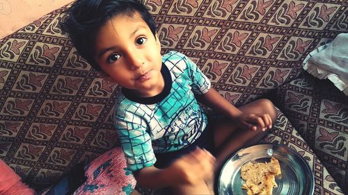 High angle portrait of girl sitting at home