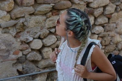 Young woman standing on rock