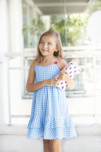 Portrait of a smiling girl standing at home