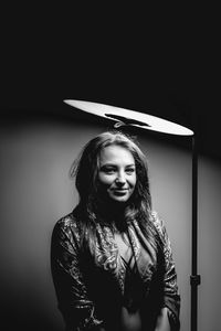 Portrait of woman by lighting equipment