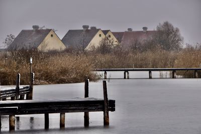 Scenic view of house on a lake with reeds and boat docks