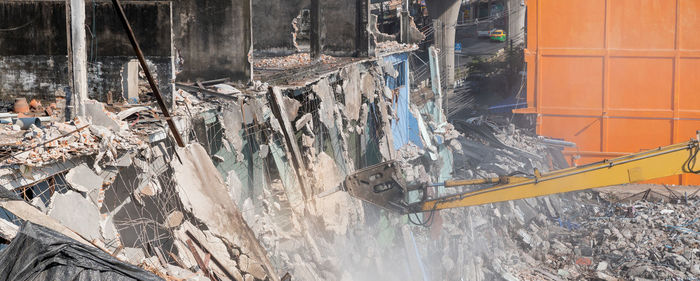 Excavator working at the construction site and the yellow backhoe work at the construction area.