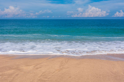 Sand beach, blue sea and sky