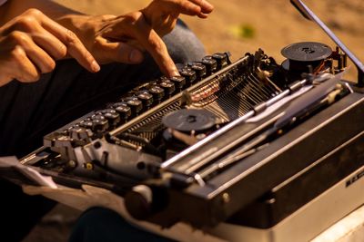 Midsection of man using typewriter