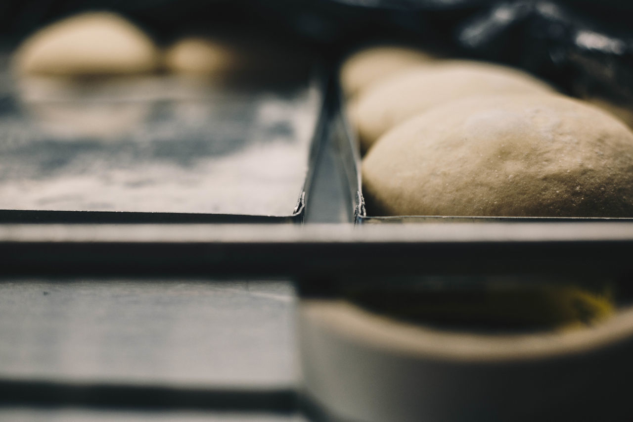 CLOSE-UP OF BREAD ON METAL TABLE