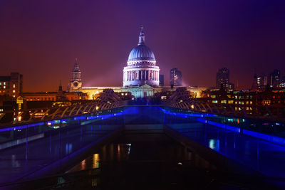 River with illuminated built structures in distance